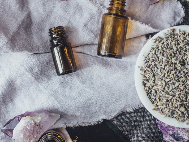 Botanical essential oil bottles on a wooden surface